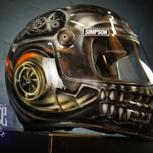 Steampunk skull motorcycle helmet with bronze metallic gears, mechanical jaw teeth, and industrial design elements on black base